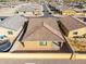 An aerial shot showing the roof, a compact backyard, and surrounding residences in a planned community at 8552 S 258Th Dr, Buckeye, AZ 85326