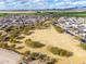 Aerial view of community park with green space, walking paths, and surrounding houses at 8552 S 258Th Dr, Buckeye, AZ 85326