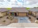 An aerial front view of a charming single-Gathering home featuring desert landscaping, an attached two car garage, and tile roof at 8552 S 258Th Dr, Buckeye, AZ 85326