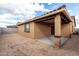Backyard view of the covered patio with a finished stucco wall at 8552 S 258Th Dr, Buckeye, AZ 85326