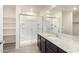 Bathroom featuring a granite countertop, modern cabinets, and tiled shower at 8552 S 258Th Dr, Buckeye, AZ 85326