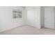 Carpeted bedroom with closet, doors, and window at 8552 S 258Th Dr, Buckeye, AZ 85326