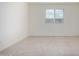Bright bedroom features a window and neutral carpet at 8552 S 258Th Dr, Buckeye, AZ 85326