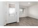 Bright entryway featuring wood-look flooring, neutral paint, and a front door with decorative glass panel at 8552 S 258Th Dr, Buckeye, AZ 85326
