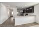 Kitchen features stainless steel appliances and granite countertops overlooking living space at 8552 S 258Th Dr, Buckeye, AZ 85326