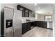 Modern kitchen features stainless steel appliances, gray cabinets and granite countertops at 8552 S 258Th Dr, Buckeye, AZ 85326