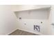 Laundry area with washer and dryer hookups and overhead shelving at 8552 S 258Th Dr, Buckeye, AZ 85326