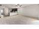Spacious living room features neutral carpet and transitions to a kitchen at 8552 S 258Th Dr, Buckeye, AZ 85326