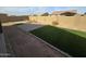 A low-maintenance backyard featuring artificial turf sections and a block wall surrounds the yard at , Maricopa, AZ 85138
