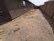 View of a dirt backyard, enclosed by a privacy fence at , Maricopa, AZ 85138