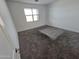 Empty bedroom space featuring bare walls, carpeting and lots of natural light at , Maricopa, AZ 85138