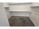 Walk-in closet with carpeted floor, white walls, and shelving provides ample storage space at , Maricopa, AZ 85138