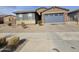 A cozy house featuring a charming stone accent, low-maintenance landscaping, and a convenient two-car garage at , Maricopa, AZ 85138