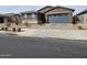 Street view of a single-story home with a blue garage door and low-maintenance rock landscaping at , Maricopa, AZ 85138