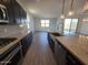Bright kitchen featuring stainless steel appliances, dark cabinets, and granite countertops at , Maricopa, AZ 85138