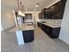 Modern kitchen with dark cabinets, a stainless steel appliances, and a large island with stylish lighting at , Maricopa, AZ 85138