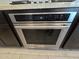 A Kitchenaid stainless steel oven is set into dark, stained kitchen cabinets at , Maricopa, AZ 85138