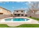 Inviting backyard featuring a private pool, lush green lawn, and covered patio for comfortable outdoor living at 1135 E Desert Holly Dr, San Tan Valley, AZ 85143