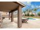Relaxing backyard oasis with a covered patio, outdoor table, and refreshing pool, perfect for entertaining at 1135 E Desert Holly Dr, San Tan Valley, AZ 85143