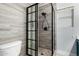 Updated bathroom featuring a modern shower with black trim and wood-look tile at 1135 E Desert Holly Dr, San Tan Valley, AZ 85143