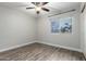 Bedroom with wood floors and a window offering a view of palm trees at 1135 E Desert Holly Dr, San Tan Valley, AZ 85143