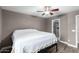 Comfortable bedroom with a ceiling fan and an ensuite bathroom with a glass door at 1135 E Desert Holly Dr, San Tan Valley, AZ 85143