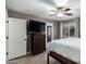 Bright bedroom with a ceiling fan, wood floors, and a closet with a mirror at 1135 E Desert Holly Dr, San Tan Valley, AZ 85143
