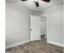 Bedroom featuring wood floors and an open doorway to a closet at 1135 E Desert Holly Dr, San Tan Valley, AZ 85143
