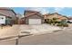 Inviting two-story home featuring a well-maintained front yard with desert landscaping at 1135 E Desert Holly Dr, San Tan Valley, AZ 85143
