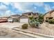 Charming home featuring desert landscaping, a spacious driveway, and a two-car garage at 1135 E Desert Holly Dr, San Tan Valley, AZ 85143