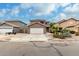 Inviting two-story home featuring a well-maintained front yard and desert landscaping at 1135 E Desert Holly Dr, San Tan Valley, AZ 85143