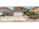 Attractive two-story home featuring a clean white garage door and desert landscaping at 1135 E Desert Holly Dr, San Tan Valley, AZ 85143