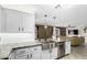 Renovated kitchen with stainless steel appliances and a view to the living room at 1135 E Desert Holly Dr, San Tan Valley, AZ 85143