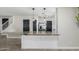 Open kitchen featuring a granite countertop island and a view into other rooms at 1135 E Desert Holly Dr, San Tan Valley, AZ 85143