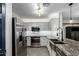 Updated kitchen with stainless steel appliances, granite countertops, and an undermount sink at 1135 E Desert Holly Dr, San Tan Valley, AZ 85143