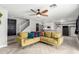 Cozy living room featuring a ceiling fan, hardwood floors, a staircase, and comfortable seating at 1135 E Desert Holly Dr, San Tan Valley, AZ 85143