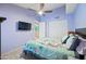 Cozy bedroom featuring a ceiling fan and a TV for relaxation at 1180 E Belmont Ave, Phoenix, AZ 85020