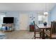 A dining room that features tile floors, natural light, a wood table and chairs, and light blue walls at 1180 E Belmont Ave, Phoenix, AZ 85020