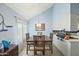 A dining room featuring a wooden table, seating for six, and a view into the kitchen at 1180 E Belmont Ave, Phoenix, AZ 85020