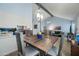 Open concept dining room with rustic wood table, stylish lighting, and view into the living area at 1180 E Belmont Ave, Phoenix, AZ 85020