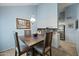 Dining room with rustic wood table, seating for four, and view of the open kitchen at 1180 E Belmont Ave, Phoenix, AZ 85020