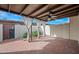 Patio with brick flooring, curtains, and a garden bed at 1180 E Belmont Ave, Phoenix, AZ 85020
