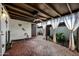 Patio with brick flooring, curtains, and a garden bed at 1180 E Belmont Ave, Phoenix, AZ 85020
