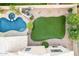 Aerial view showcasing a sparkling pool, lush landscaping, and grassy yard at 1321 N Bronco Ct, Gilbert, AZ 85233