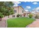 Spacious backyard with artificial turf, fruit trees, and a covered patio at 1321 N Bronco Ct, Gilbert, AZ 85233