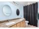 Bright bathroom features double sinks with granite counters and decorative mirrors at 1321 N Bronco Ct, Gilbert, AZ 85233