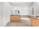 Bright bathroom with soaking tub, granite counters, and tiled floors at 1321 N Bronco Ct, Gilbert, AZ 85233
