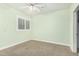 Bedroom features a ceiling fan, and a window with wooden shutters at 1321 N Bronco Ct, Gilbert, AZ 85233