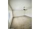 Bright, spacious bedroom with neutral carpet, fan and plenty of natural light from large windows at 1321 N Bronco Ct, Gilbert, AZ 85233