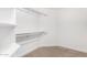 Walk-in closet features built-in shelving and carpeting at 1321 N Bronco Ct, Gilbert, AZ 85233